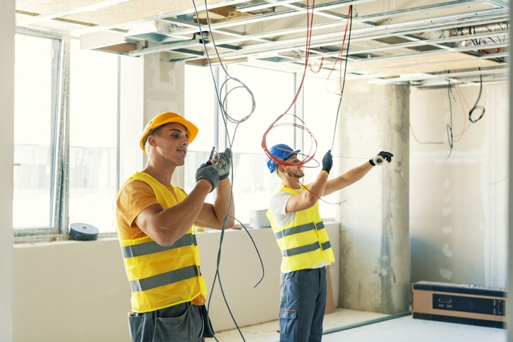 Electricians wiring a new build